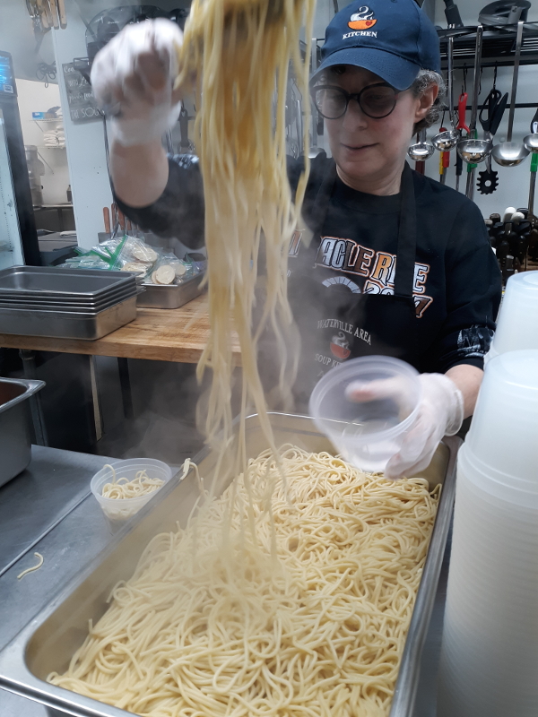 Volunteer packaging spaghetti