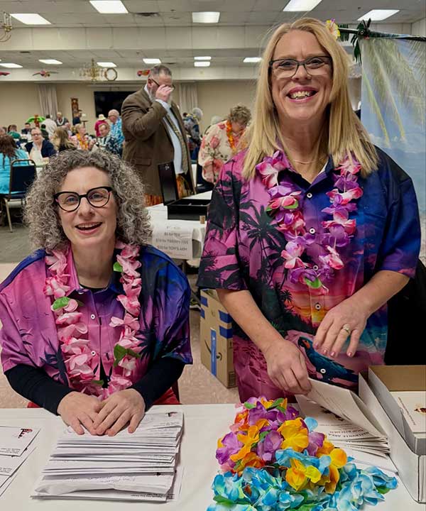 Ladies with Leis at registration table